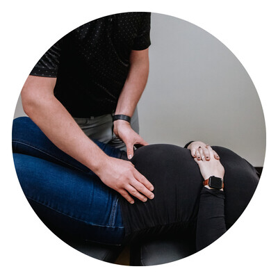 Pregnant woman getting adjusted by chiropractor
